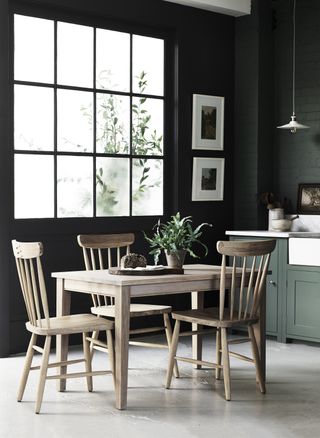 small rectangular dining table in dark kitchen by Neptune