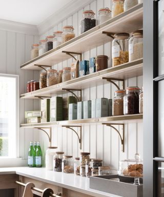 A wood and white pantry with wooden open shelving