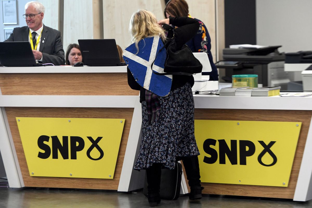 Woman at SNP conference with a Scottish shield