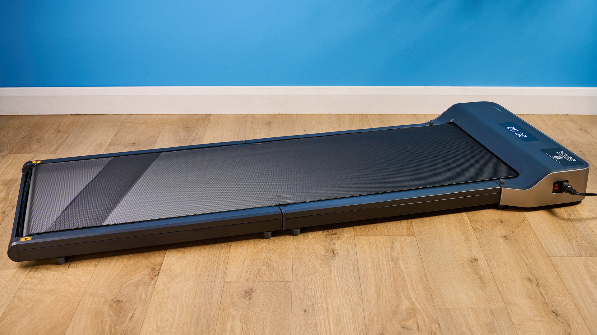 The WalkingPad Z1 photographed in front of a blue background.