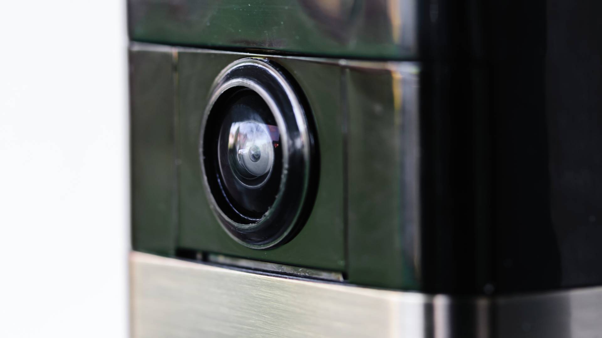 A close up on the lens of an internet-enabled, video doorbell which records video of movement, and alerts users via their smartphone.