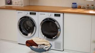Modern laundry room with white cabinets