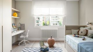 white column radiator under window in child's bedroom