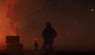 Dr. Serizawa kneels in front of a weakened Godzilla in Godzilla: King of the Monsters