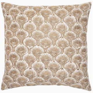 white and gold throw pillow on a white background