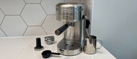 The KitchenAid Artisan Espresso Machine KES6503 on a kitchen countertop with all its accessories
