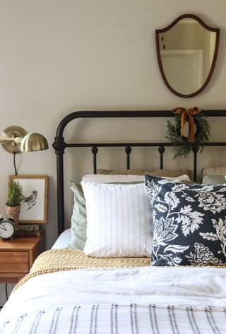 A bed with a wreath on the headboard