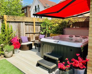 hydrolife hot tub with red canopy in garden