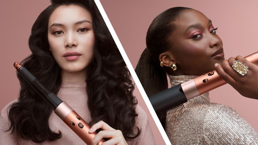 Woman using Dyson hair styler in Amber Silk colorway