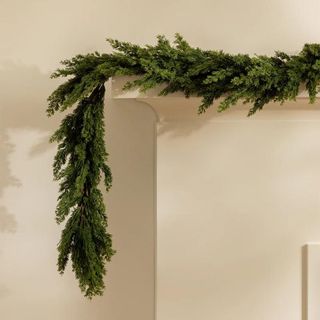 Faux Cedar Pine Garland against a cream background.