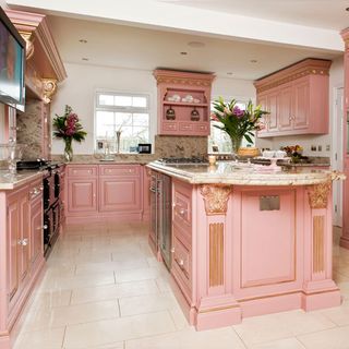 kitchen with white wall pink cabinets white flooring