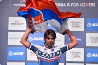 Peter Sagan waves the Slovakian flag above his head
