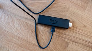 Amazon Fire TV Stick 4K Max plugged in on desk