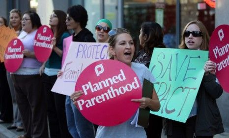 Planned Parenthood supporters rally at a protest for the clinic. While many states have tried to strip Planned Parenthood of all federal funding, Indiana is the first state to do so. 