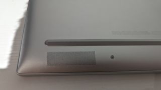 A silver HP Envy 16 laptop sitting on a table