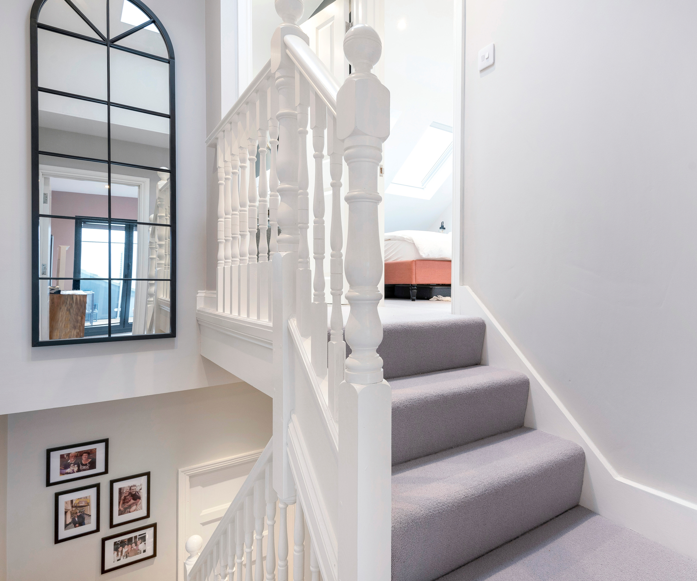 grey carpeted loft conversion stairs with white painted handrails, spindles and posts