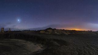 Venus, Jupiter and a partially eclipsed moon light up the sky over Mina de São Domingos at the Dark Sky Alqueva Reserve in Mértola, Portugal.