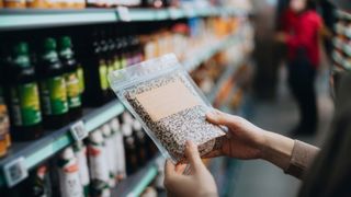 woman shopping for quinoa at the grocery store