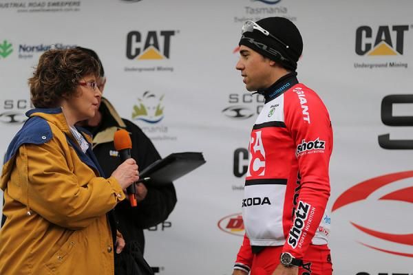 Norris speaks on the podium at the end of the final road stage in Tasmania