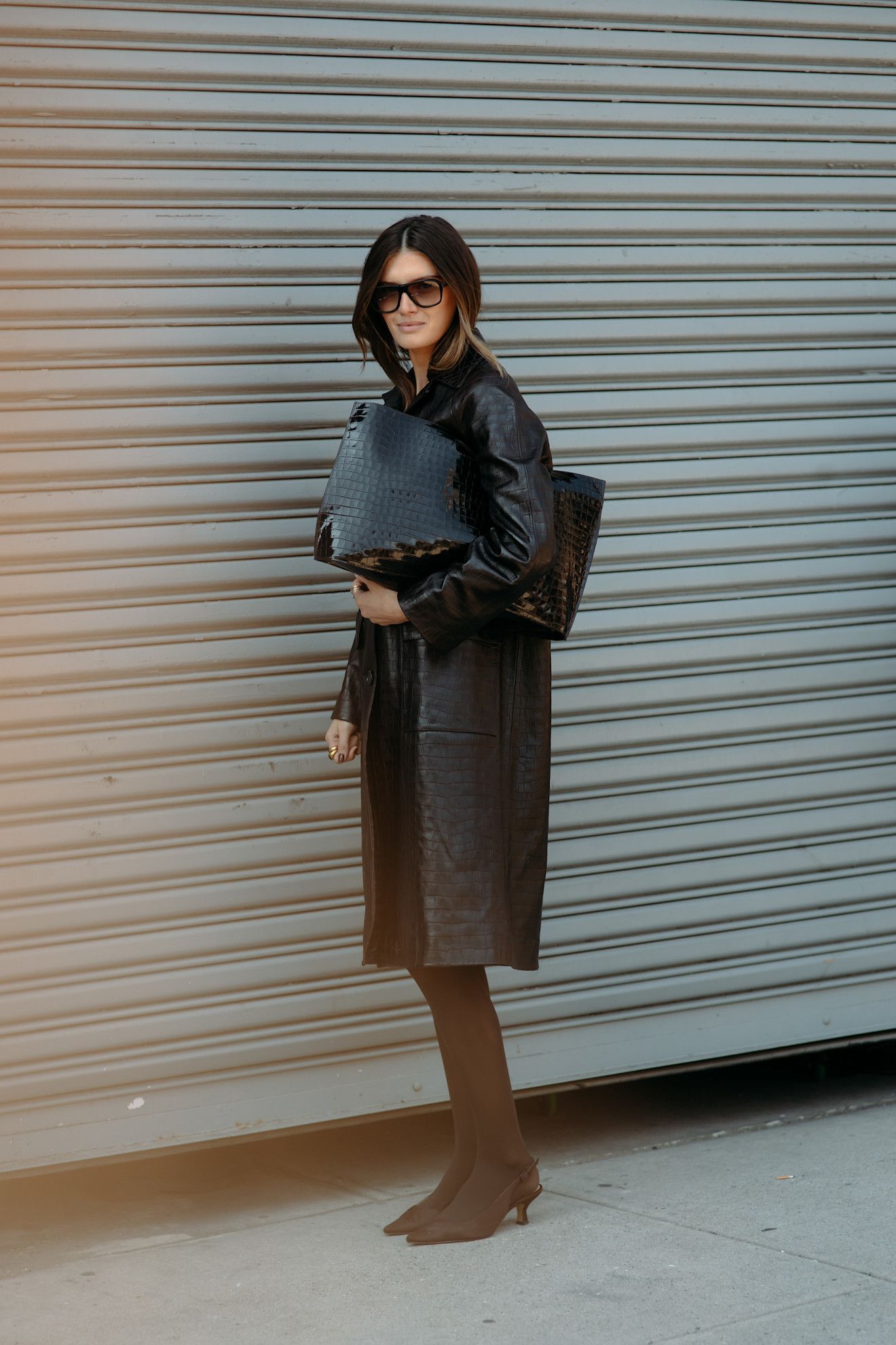 A guest wearing a croc leather coat at the COS F/W 25 show during NYFW.