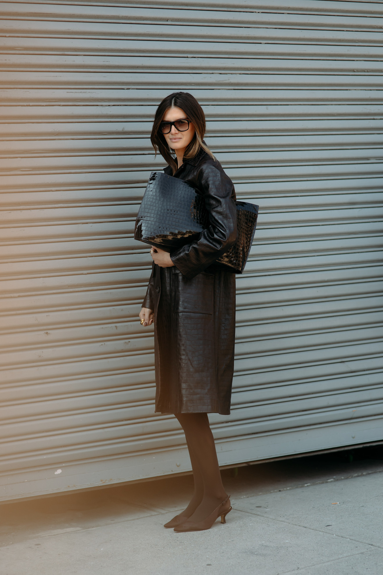 A guest wearing a croc leather coat at the COS F/W 25 show during NYFW.