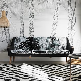 living room with sofa and tropical jungle prints wallpaper