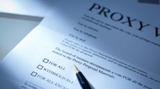 A proxy vote business letter with a pen resting on the document symbolizing a shareholder vote