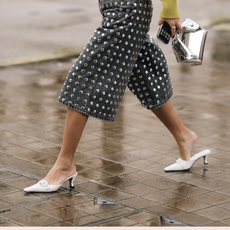 woman wearing white heels and denim culottes
