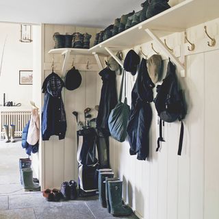 boot room with golden hooks for hanging cloths