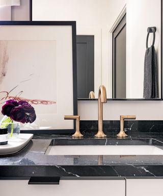 Gold tap, black countertop