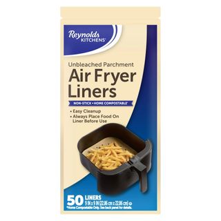 A blue and beige packet of parchment air fryer liners with an image of an air fryer basket filled with cooked fries