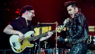 Neil Fairclough and Adam Lambert perform on stage with Queen & Adam Lambert at O2 Arena on January 17, 2015 in London, United Kingdom.