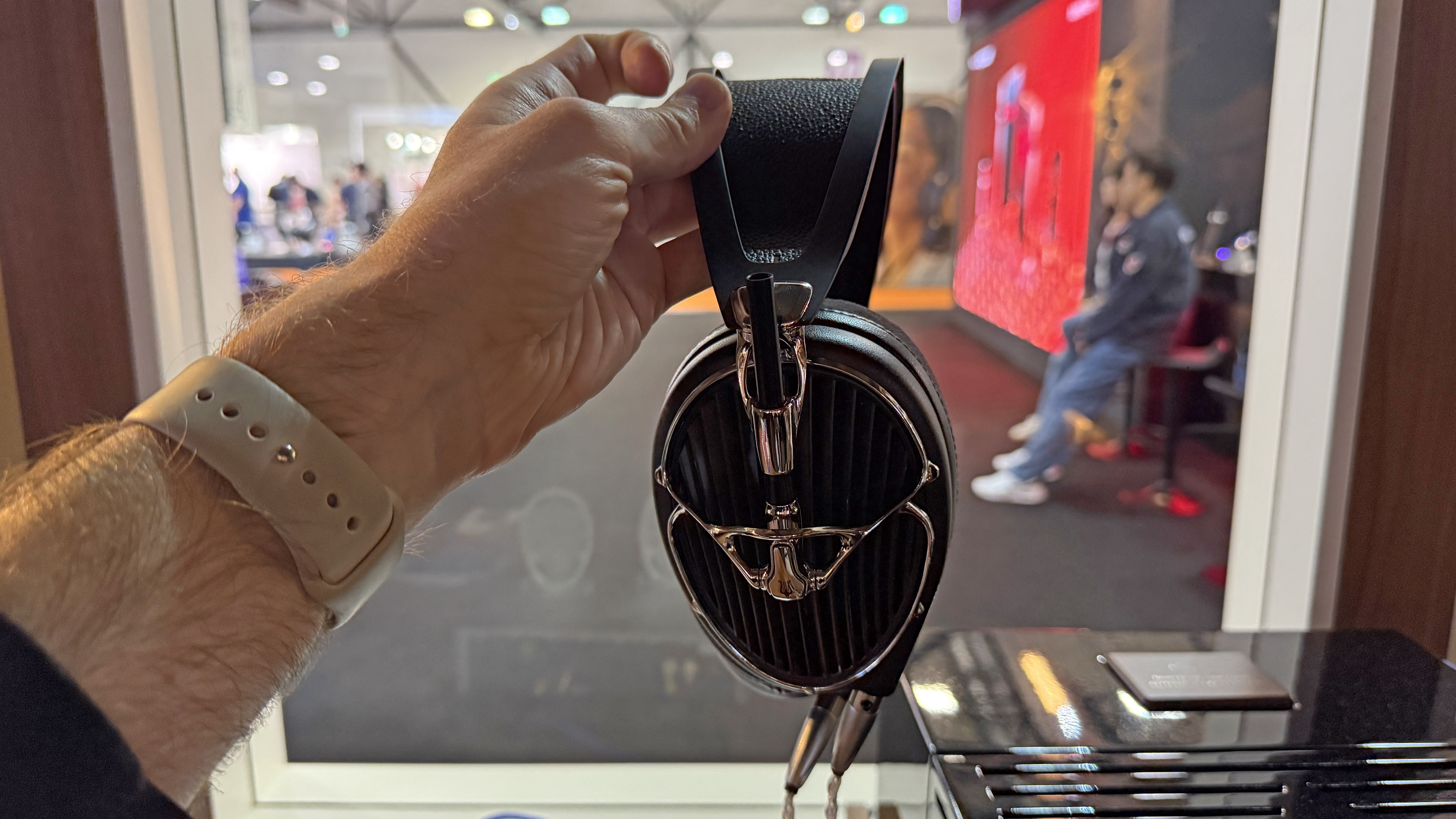 Meze Audio Arta headphones held in a man's hand