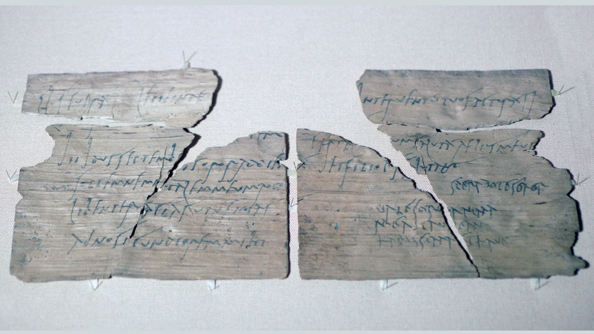 fragmentary piece of thin wood with black ink writing on it