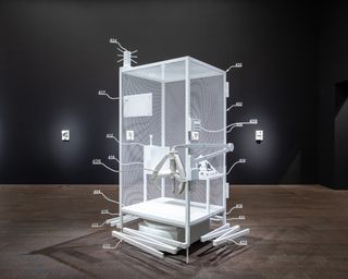 Installation view of Simon Denny, Amazon worker cage patent drawing as virtual King Island Brown