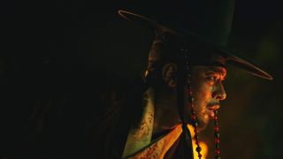 a man wearing traditional korean clothing and hat with blood splattered on his face