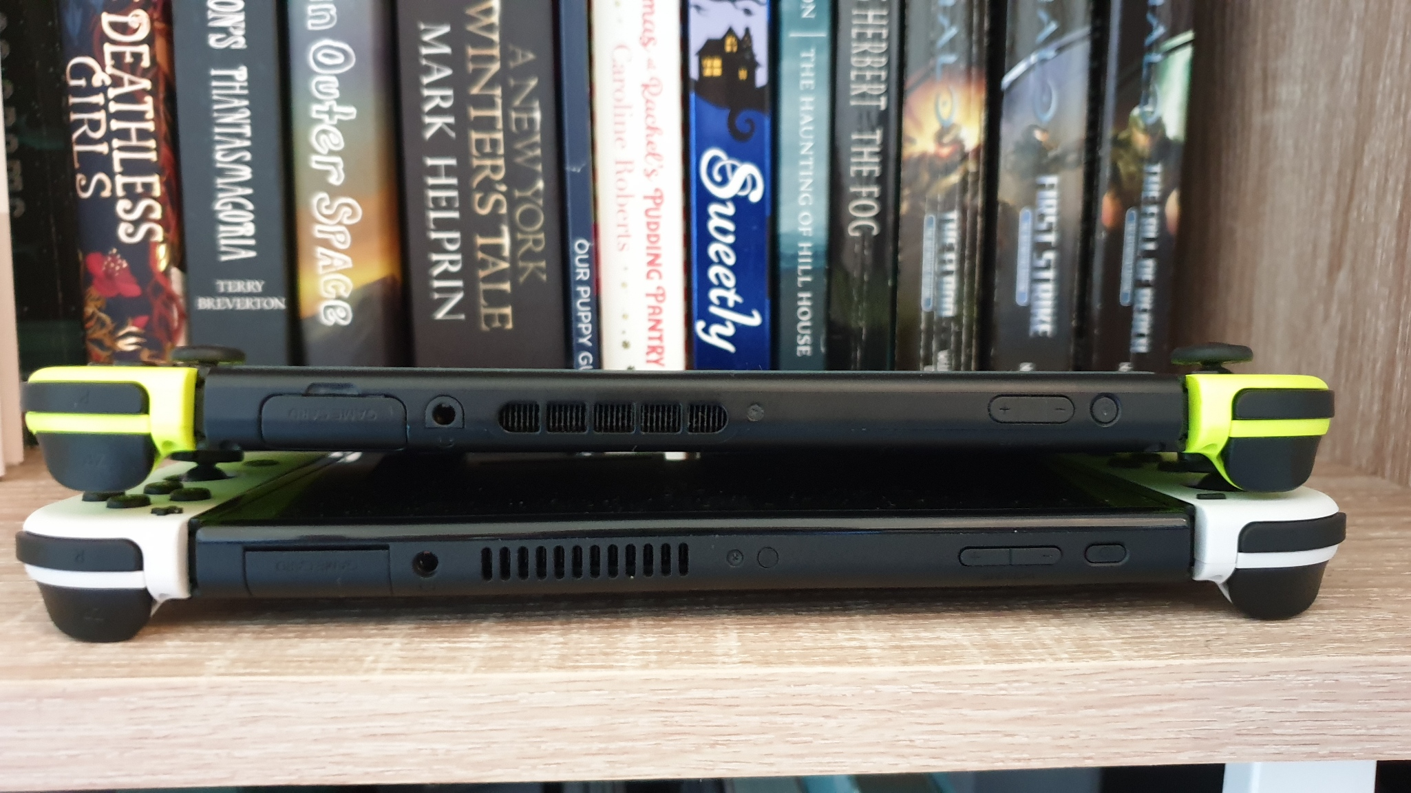 Nintendo Switch OLED stacked on top of the older Switch