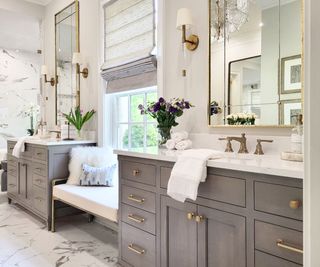 grey bathroom with built-in seating and marble floor and bathroom wall lights