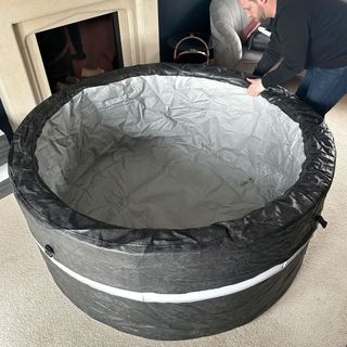 The Wave Osaka hot tub being assembled in a carpeted living room