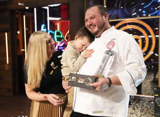 Season 13 MasterChef Winner Grant accepts the trophy from Gordon Ramsay and co.