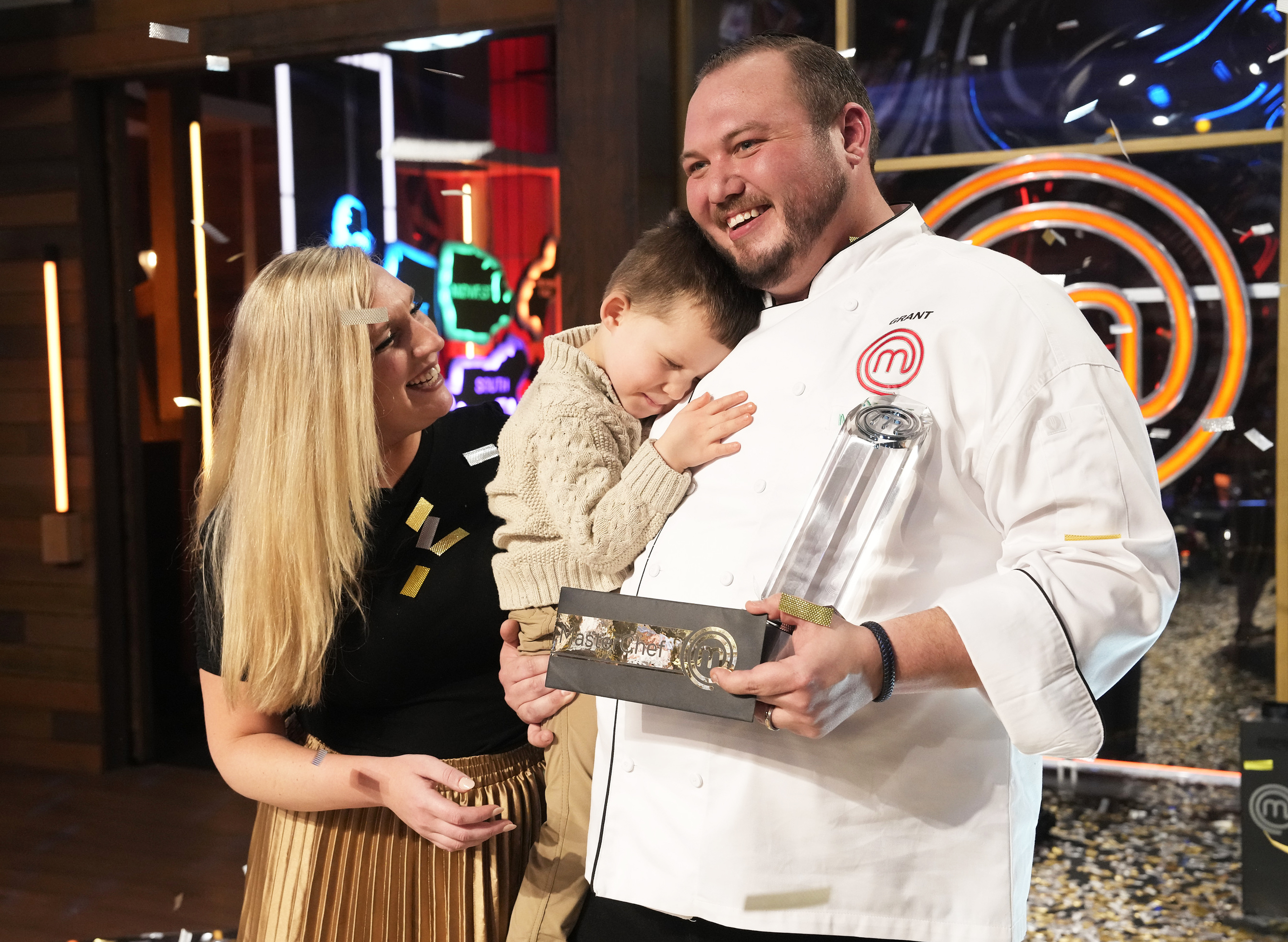 Season 13 MasterChef Winner Grant accepts the trophy from Gordon Ramsay and co.