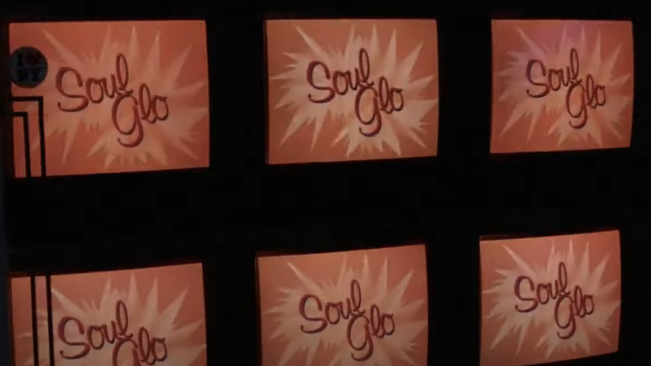 TVs displaying the Soul Glo ad from Coming to America
