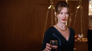 Yael Grobglas as Shae Banfield holding a glass in Matlock