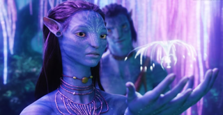 Still from "'Avatar" showing one of the film's blue-skinned Na'vi aliens holding a floating, iridescent jellyfish creature