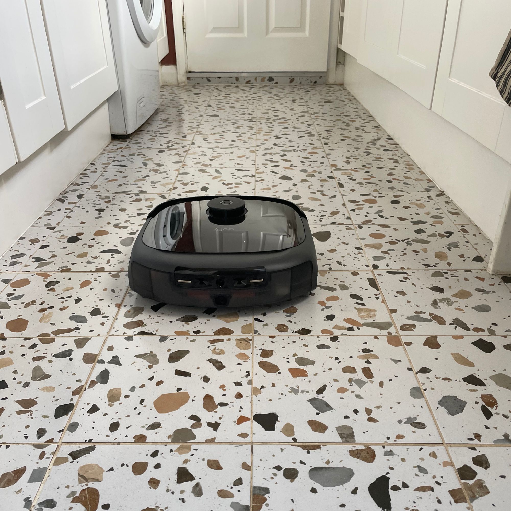 Eufy Robot Vacuum Omni E25 on terrazzo tiles in a kitchen