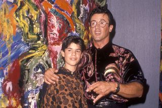Sylvester Stallone with his arm around a young Sage Stallone