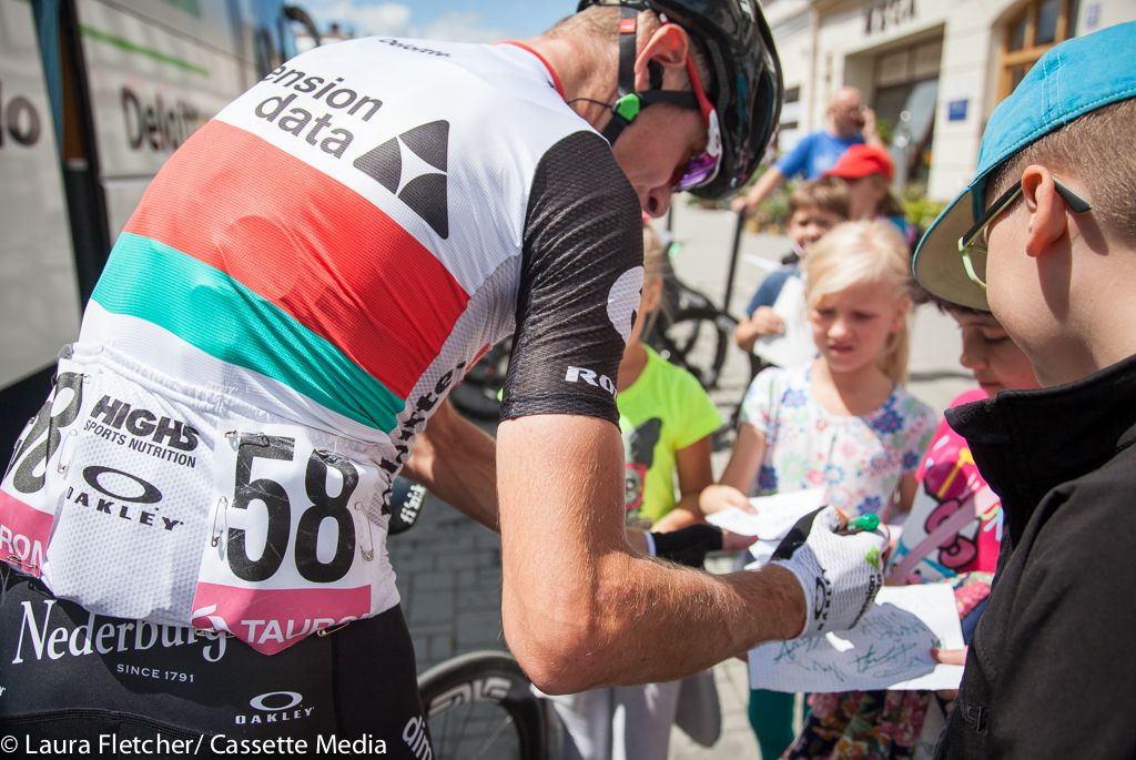 Kanstantsin Siutsou greets some young fans at a startline in Poland