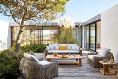A decked outdoor area with resin wicker outdoor furniture