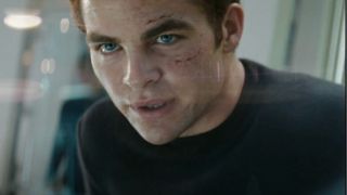 Chris Pine sits on the bridge with a determined expression in Star Trek.