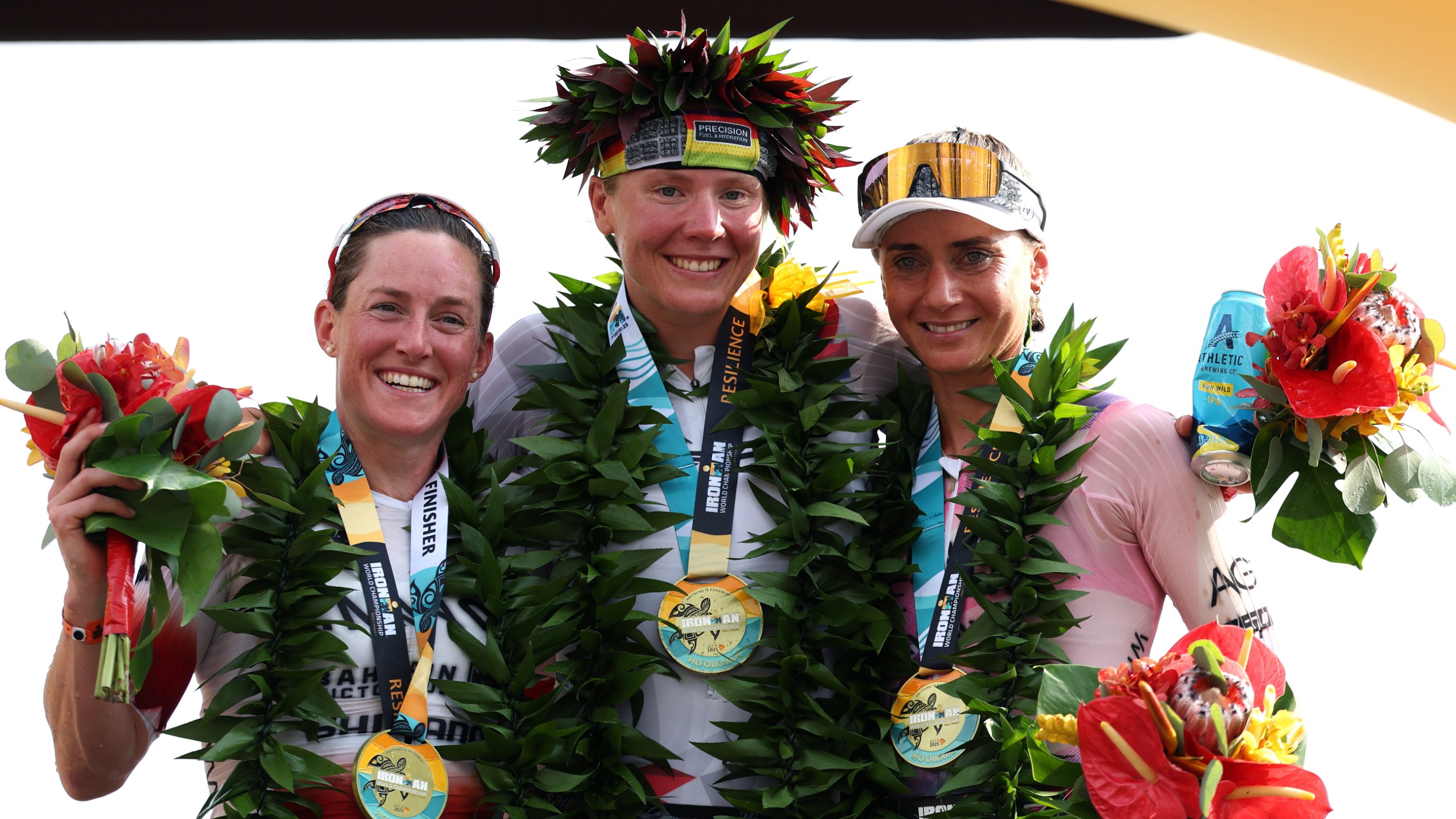 Kat Matthew of the United Kingdom, Solveig Lovseth of Norway and Laura Philipp of Germany pose after the 2025 IRONMAN World Championship Women's Race on October 11, 2025 in Kailua Kona, Hawaii